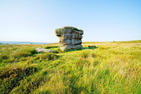 Thr Eagle Stone gritstone outcrop standing on Baslow Edge on asummer morning
