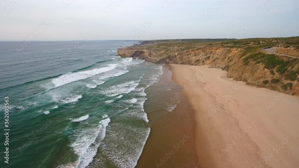 Sticker Aerial video shooting. Beautiful scenery of the beach for surfing, fishing Monte Clerigo on the Atlantic coast. Portugal, Sagres, Algarve, Aljezur.