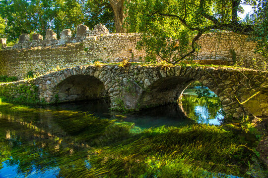 View of the Roman bridge of Ninfa, an ancient medieval town located in the province of Latina, Italy. Now it is part of the complex of Ninfa gardens.