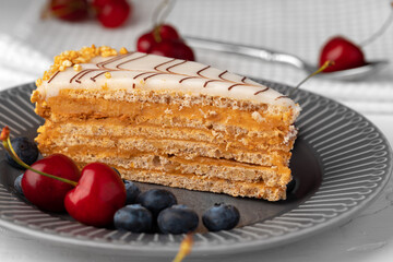 Piece of esterhazi cake decorated with fresh berries