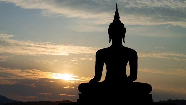 Buddhism: Ancient Statue of Buddah at Sunrise, Time Lapse with Colorful sky, Bangkok, Thailand