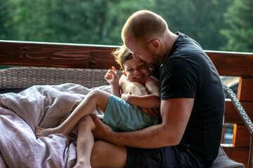 Young father holding his son up in the air. Dad and toddler having amazing time together. Father...
