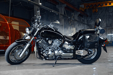 Motorcycle standing in a dark hangar building