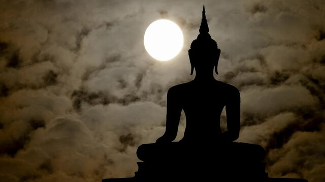 Buddah in Dark Atmosphere: Time Lapse by Night with Full Moon, Bangkok, Thailand