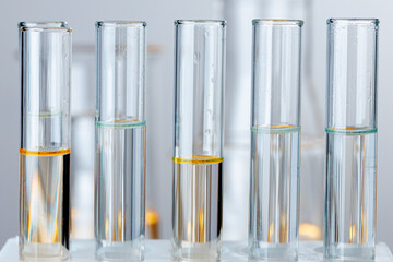 Laboratory glass test tubes with transparent liquid close up