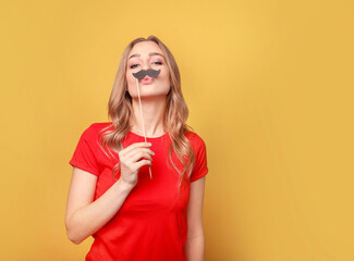 Funny woman with mustache on yellow background