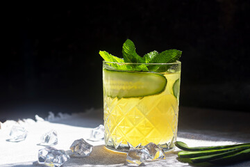 Refreshing summer strong cocktails with a slice of lime. Alcoholic drink. Garnished with a sprig of mint, citrus and ice cubes. In the bar.
