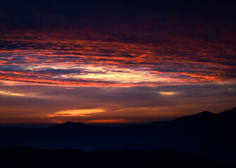Colorful, vibrant, burning sunset skies, dramatic clouds  Himalayan mountains on Trek to Dalhousie
