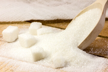 Wooden spoons and sugar. Diet. A lot of sugar.