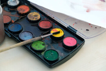watercolor painting materials, watercolor colors on the table are mixed with each other,