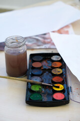 watercolor painting materials, watercolor colors on the table are mixed with each other,