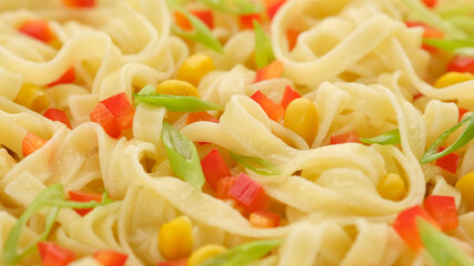 noodles with paprika, green onion and sweet corn, top view