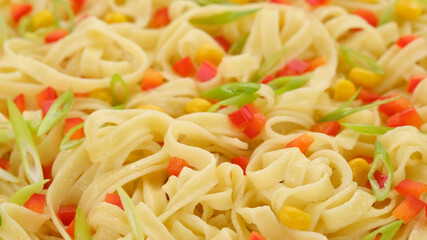noodles with paprika, green onion and sweet corn, top view