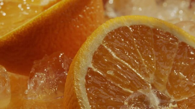 Oranges in ice rotating with changing light