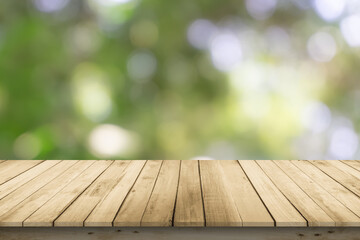 Abstract natural spring blurred garden leaves view from living room window with wooden table...