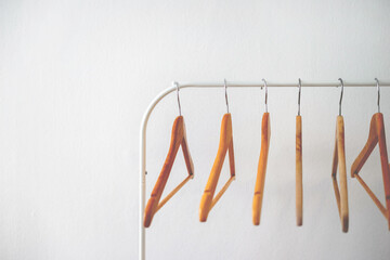 Empty wooden cloth hangers on white background copy space minimalism style, Selected focus, retro vintage grainy film look.