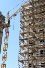 Fototapeta na wymiar Construction site with scaffolding and crane