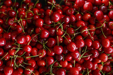 Close up of a large collection of red cherries on the market