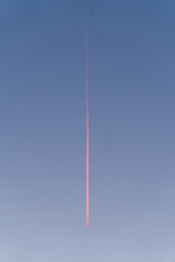 A airplane in the sky during sunset.