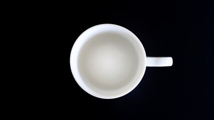 White coffee cup top view on black background