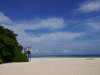 White sand beach with fleecy clouds