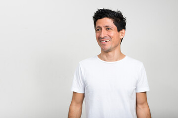 Portrait of happy Hispanic man thinking and looking up