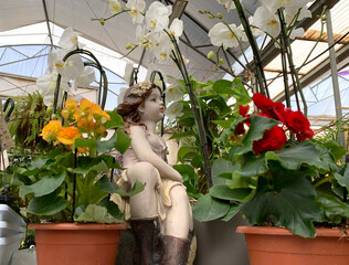 Garden sculpture of a girl surrounded by flowers