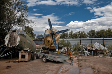 airplane cemetery, an old broken rural glider plane stands in the backyard of the airport