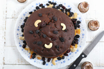 Plum cake made with dried fruit, raisins, cashew nuts, almond etc. Tasty home made cake flavored with cinnamon and spices for sale on Christmas and new year Kerala India.