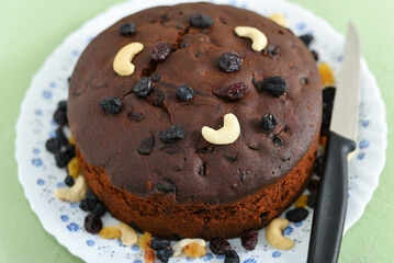 Plum cake made with dried fruit, raisins, cashew nuts, almond etc. Tasty home made cake flavored with cinnamon and spices for sale on Christmas and new year Kerala India.