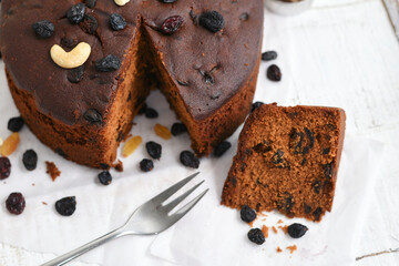 Plum cake made with dried fruit, raisins, cashew nuts, almond etc. Tasty home made cake flavored with cinnamon and spices for sale on Christmas and new year Kerala India.
