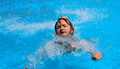 A girl is swimming in the pool.