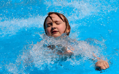 A girl is swimming in the pool.