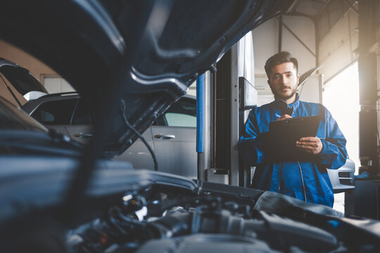 Auto mechanic fills in car repair documentation. Car service concept