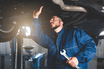 Auto mechanic inspects car suspension. Diagnostics of the condition of the car 