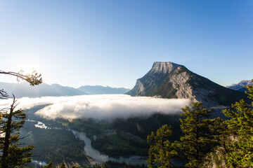 Fototapeta na wymiar low cloud on a sunrise in the mountain peak showing on top