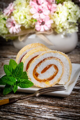 Obraz na płótnie Canvas Slices of homemade sweet roll with fruit jam.