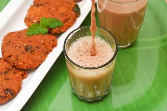 Indian milk tea or Chai and Parippu vada , Dal vada Kerala tea time snacks, popular deep fried hot and spicy food. Traditional food for Ramadan, Eid, Iftar pary, Onam, Vishu. Local street food India.