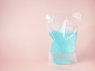 Blue alcohol gel on pastel pink background. Top up package.
