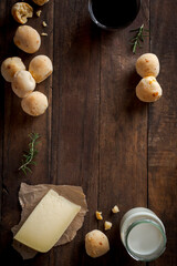 Frame with cheese bread, coffee, milk and slice of cheese top view