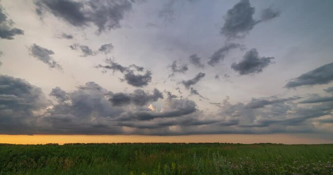 time lapse landscape of clouds at sunset over the field
