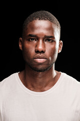Fototapeta premium Close up portrait standing black man looking at camera wearing a white t-shirt