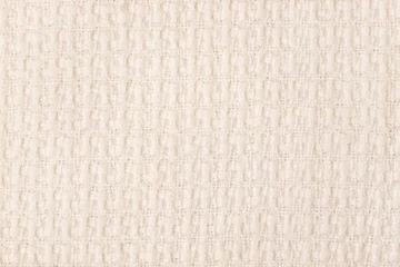 Fotobehang Beige knitted fabric texture background, machine knitting texture. Light bedcover close-up © lermont51