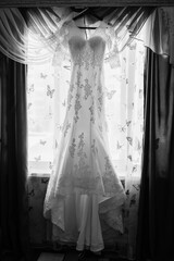 wedding dress on a hanger, wedding dress with train, gathering the bride