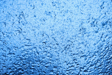 Fototapeta na wymiar Blue abstract glass background, selective focus.
