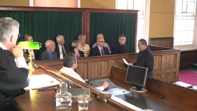Male Barrister / Lawyer addressing the Jury in Court or Courtroom. Wide Shot. Stock Video Clip Footage
