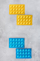 Set of various tablets in blister pack. Healthcare and medical concept. Close up, gray background, copy space