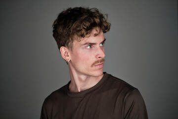 Obraz premium portrait of a young blond man with mustache looking at his left
