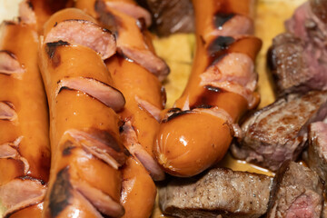 Close-up of well-cooked steaks and sausages