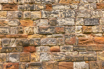 Part of the wall of an old historic building of natural volcanic stone
